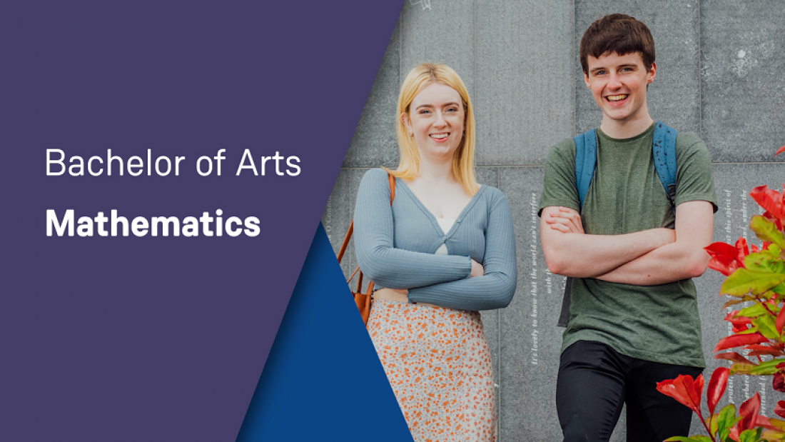 A female and male student are pictured smiling at the camera with their arms folded and standing in front of a grey wall. 