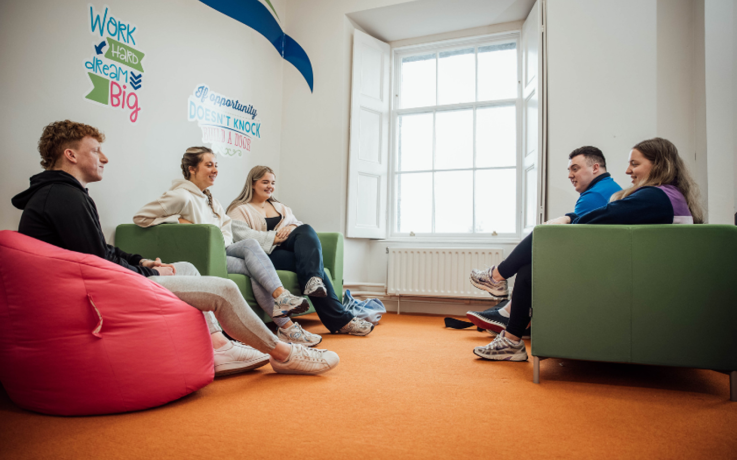 A group of students chatting in a meeting area in MIC Thurles