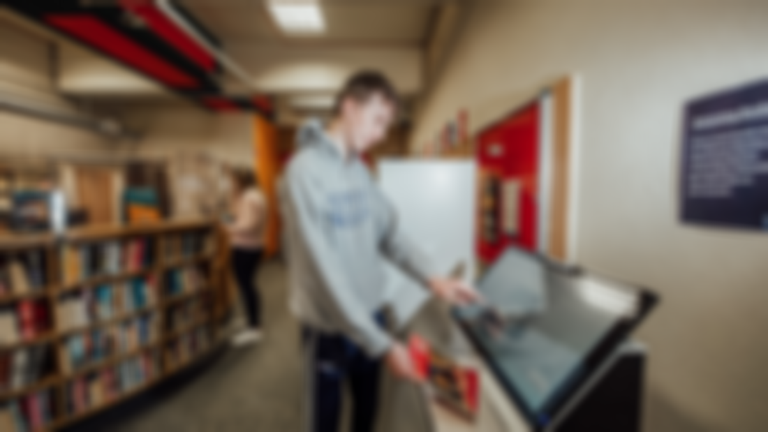 Student checking a book back in at the MIC Limerick Library