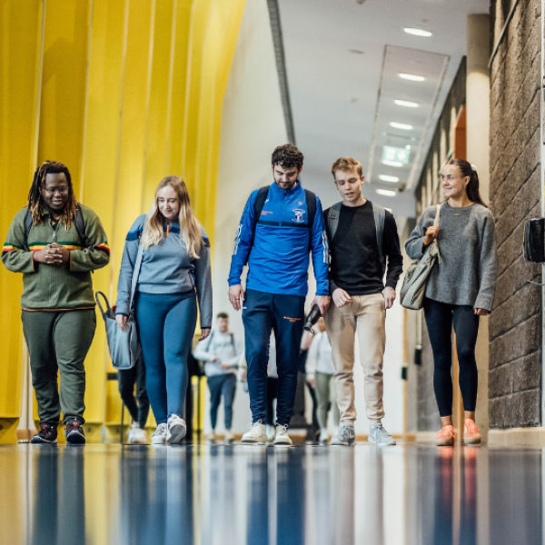 Group of students walking in the TARA Builiding
