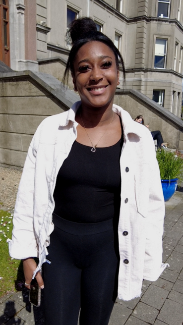 Female MIC student standing in front of the Foundation Building.