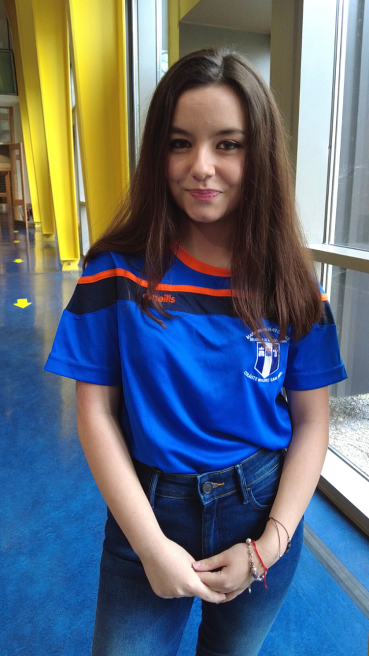 Female student standing in the forum in the Tara building at MIC.