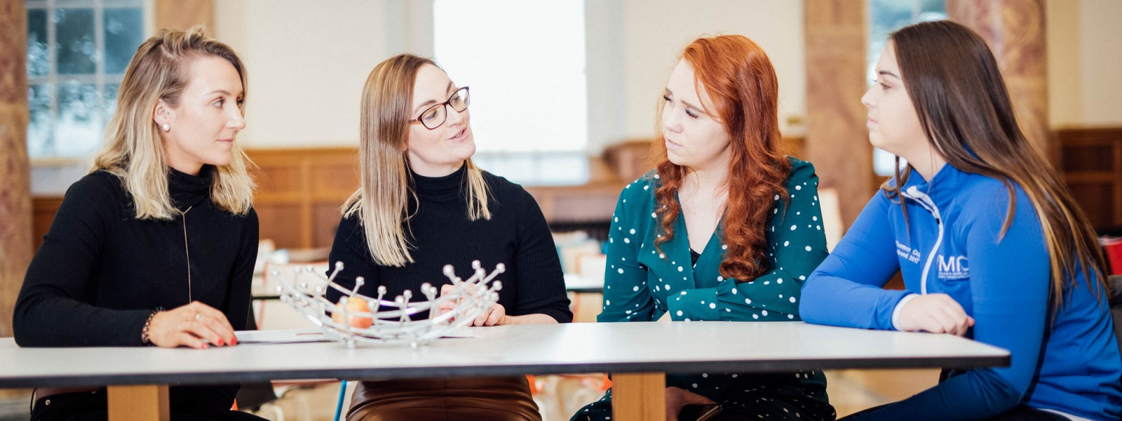 4 female students in MIC Thurles sitting in College canteen chatting