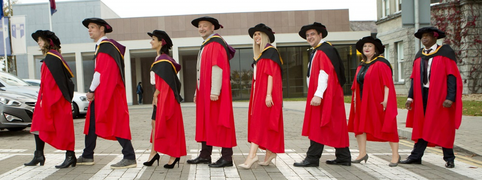 MIC Doctoral Students walking in front of College building