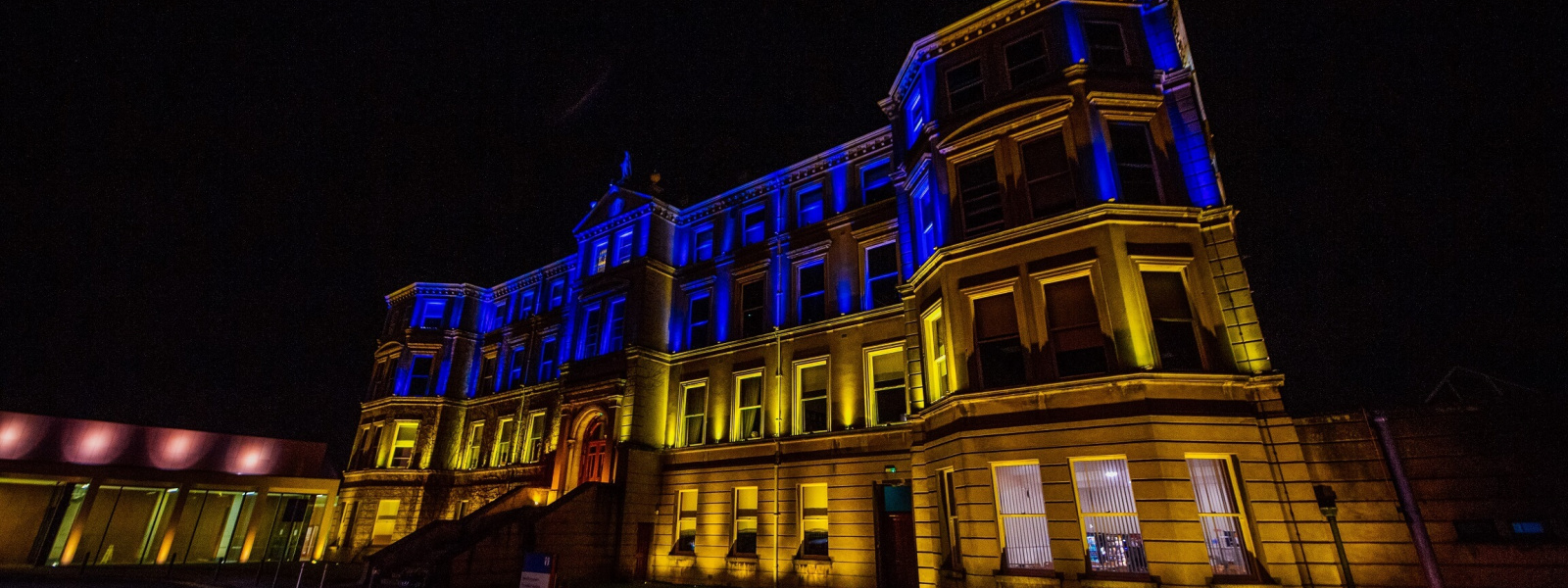 Mary Immaculate College Foundation Building lit up with Ukranian colours