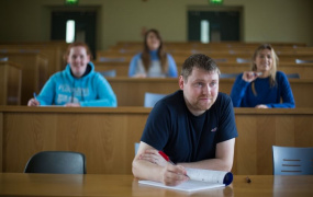 male mature student in a lecture theatre in MIC Thurles with several students behind him