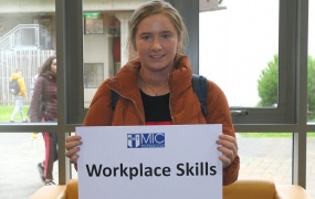 Student pictured at Mary Immaculate College holding a sign saying 'Employability'