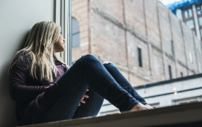 Woman looking out window