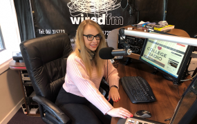 MIC student, Vanessa Flood, pictured sitting at the mic in the Wired FM radio studio