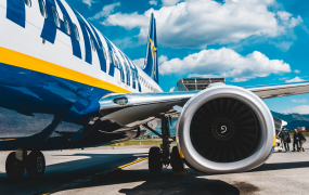 Ryanair plane parked in airport with people boarding 