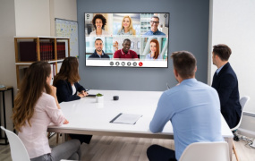 Office workers looking at a virtual meeting screen