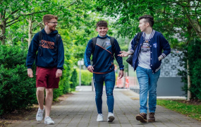 three male students talking and walking through the MIC Limerick campus