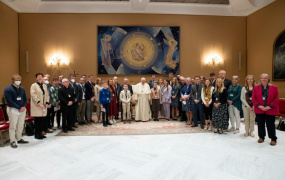 GRACE educators standing either side of Pope Francis in the Vatican