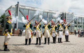 Re-enactment of French soldiers firing traditional weapons