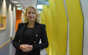 Professor Niamh Stack standing in front of corridor