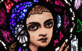 A stain glass depiction of St Brigid