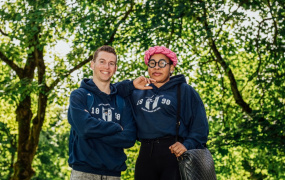 Male and female student standing in front of trees at MIC's Limerick campus