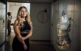 Amy Tobin standing beside half mannequin with chains around it