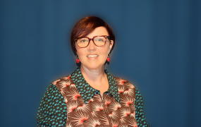 Dr Orla Slattery in front of blue backdrop