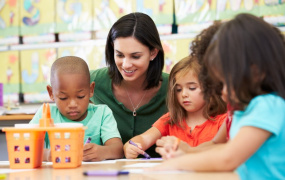 Teacher around table with three students