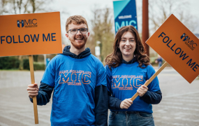 Male and female student pictured at an open day