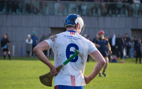 Mary Immaculate College hurler at match with back to camera resting