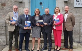 Report authors holding copies of the report