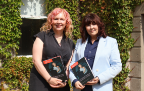 Dr Deirdre Flynn and Dr Susan Liddy holding a copy of their book
