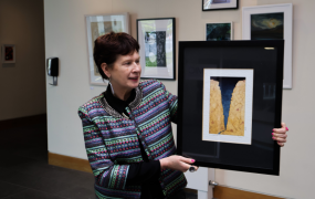 Dr Patricia Kieran holding one of de’ Angeli's paintings