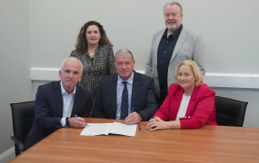 A group of people signing a Memorandum of Understanding between MIC and Kerry ETB