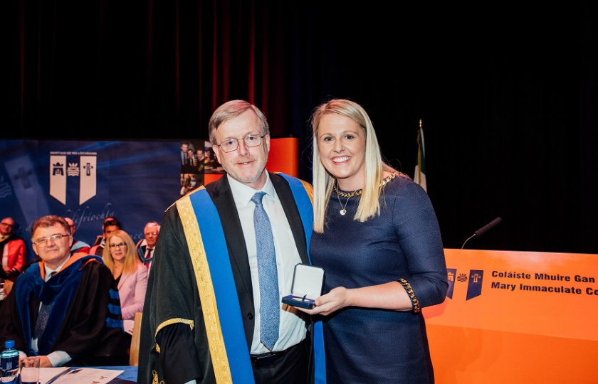 Professor Eugene Wall presents Jacqui Hurley with her Alumna of the Year award
