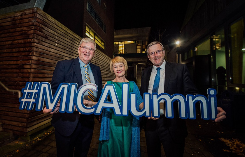 Pat McDonagh, Roisin Meaney and Professor Eugene Wall holding an #MICAlumni sign.