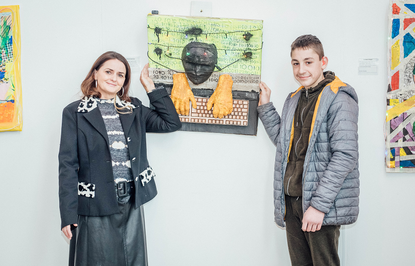 Artist, Shiela Richardson pictured with student, Calvin Ambrose and his artwork at the exhibition launch