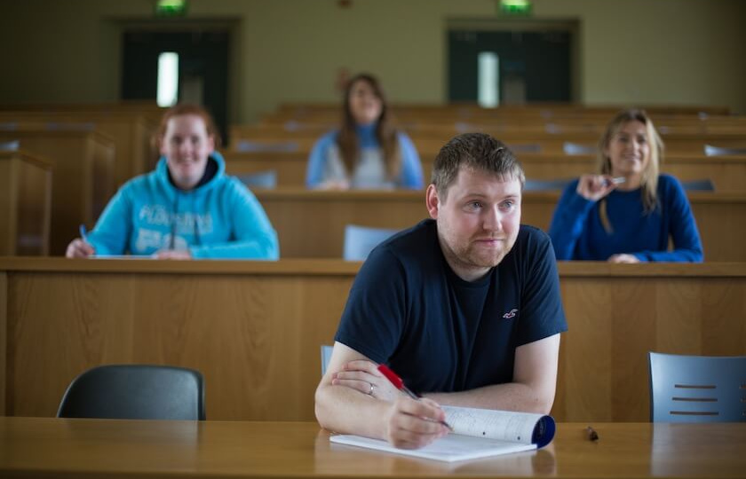 male mature student in a lecture theatre in MIC Thurles with several students behind him