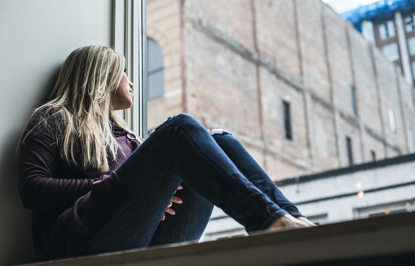 Woman looking out window