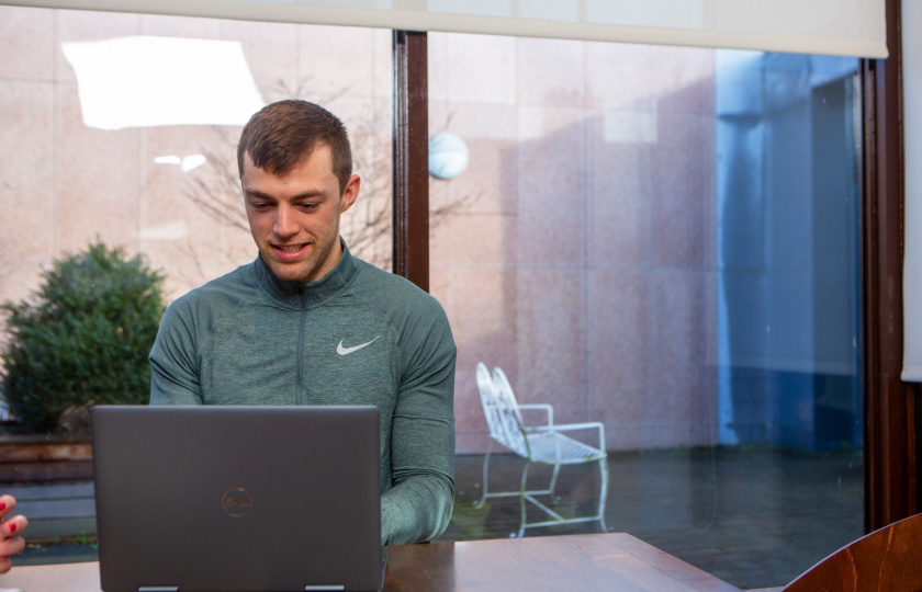 MIC student sitting at laptop