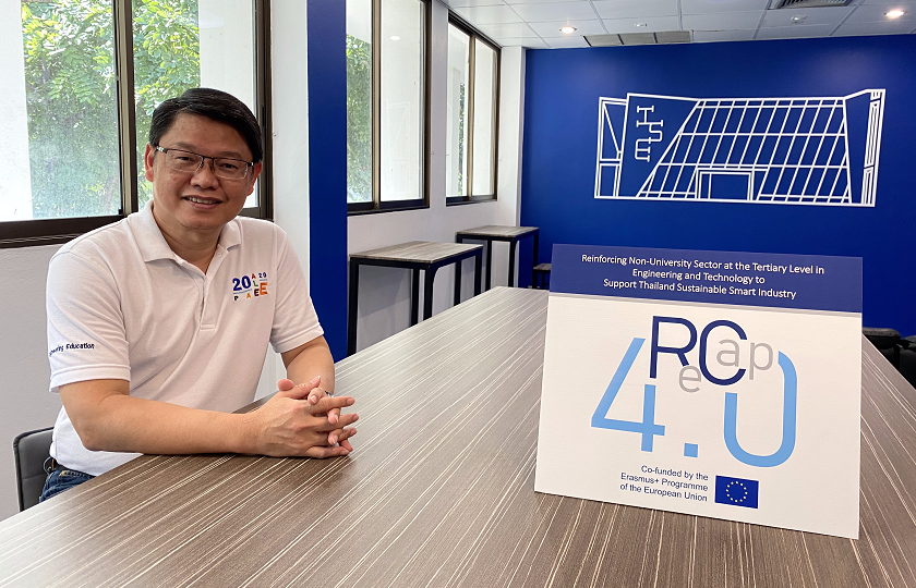 Project leader Dr Pisut Koomsap pictured in a board room in the Asian Institute of Technology. Dr Koomsap is pictured sitting with his hands on a table. Also on the table is a sign saying ReCap 4.0