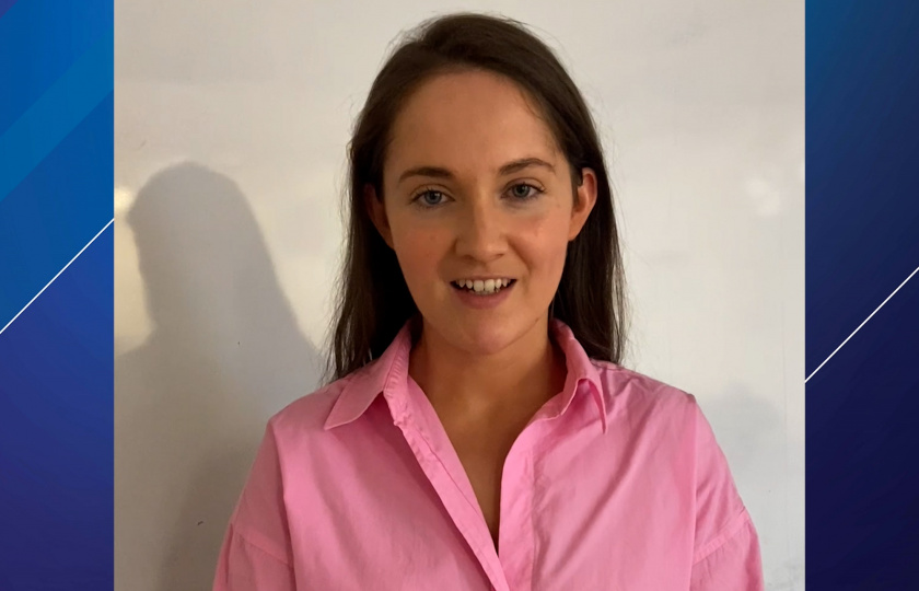 Woman pictured with brown hair wearing a pink shirt