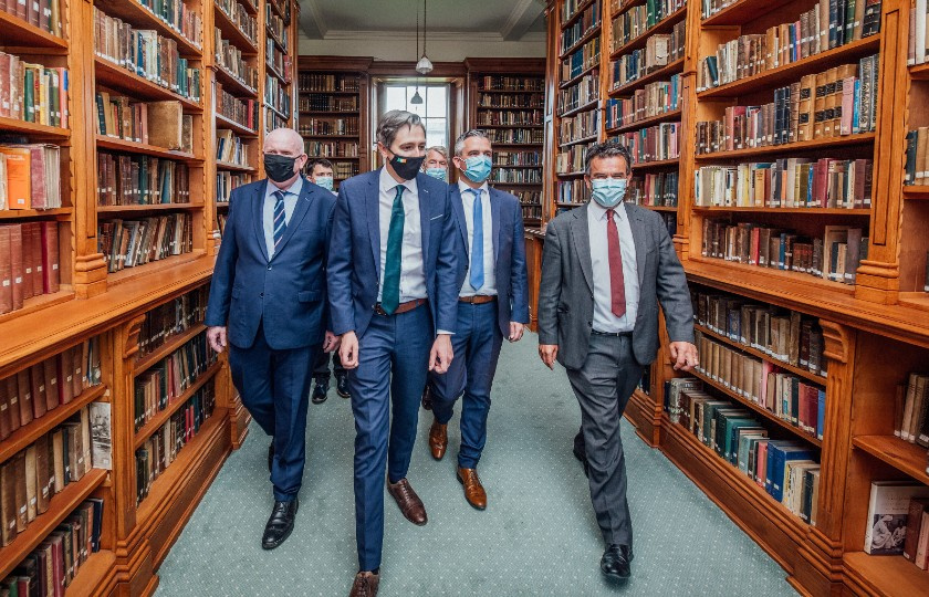 Minister Harris walks through the MIC Thurles library with Dr Finn Ó Murchú