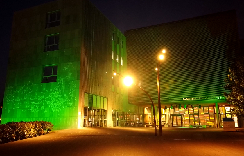 The TARA building on MIC's Limerick campus lit up in green 