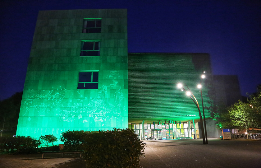 TARA Building on MIC Limerick campus lit up in green 