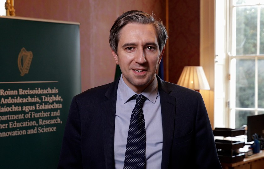 Minister Simon Harris standing in his office