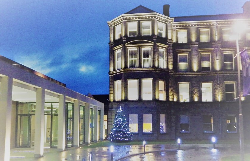 Image of MIC Foundation Building at night with Christmas tree