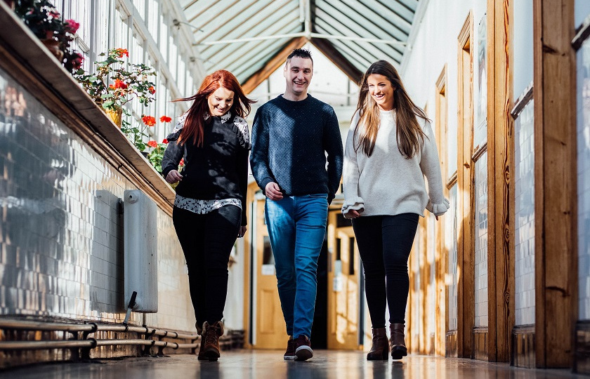 Postgraduate students at Mary Immaculate College walk through a corridor on the MIC Limerick campus