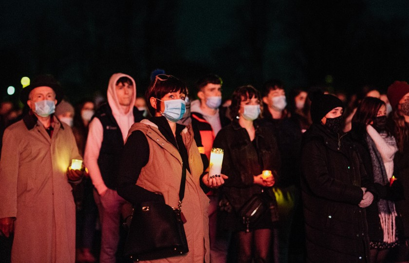 Members of the crowd holding candles