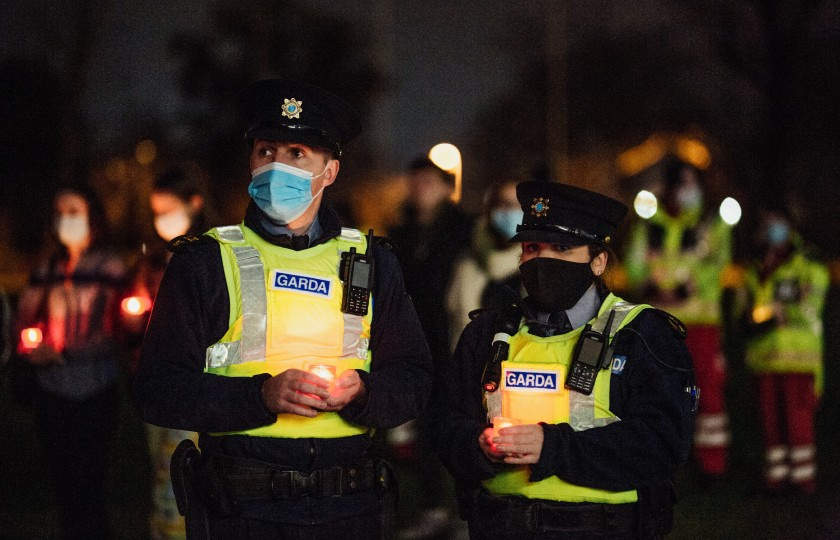 Two Gardai holding candles
