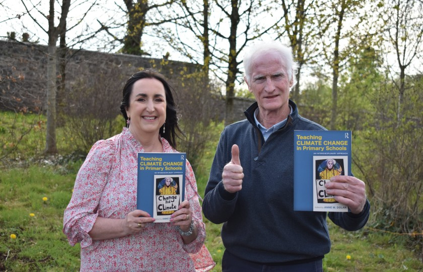 Dr Anne Dolan and Duncan Stewart holding the Teaching Climate Change in Primary Schools