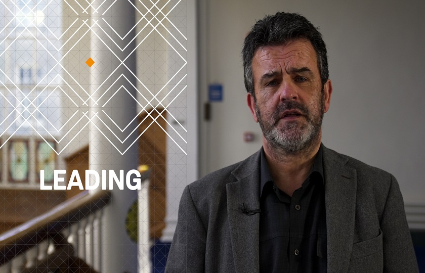 Dr Finn Ó Múrchú, programme coordinator of the M Ed in Middle Leadership & Mentoring with the word 'Leading' on screen