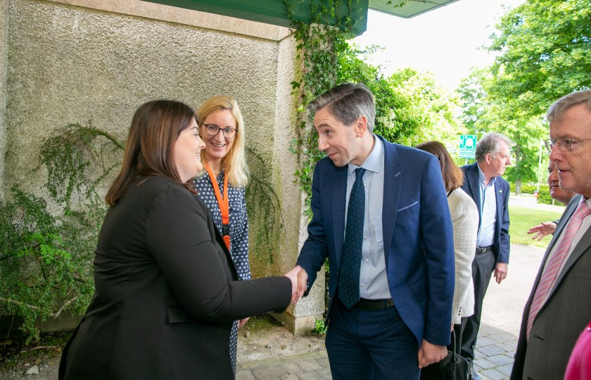 Minister Simon Harris shakes hands with Aoife Gleeson