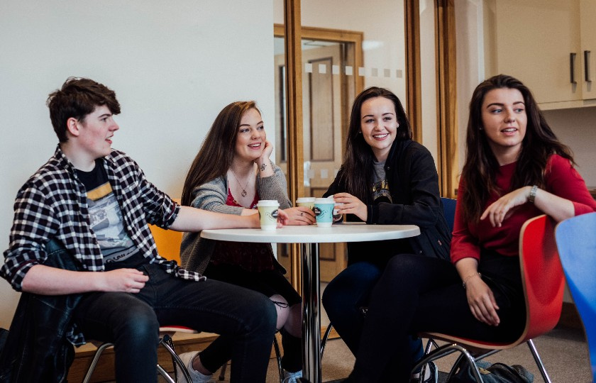 Students talking around a table